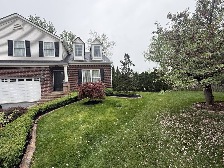 Front yard after a complete landscape makeover with new beds, mulch and trimmed turf