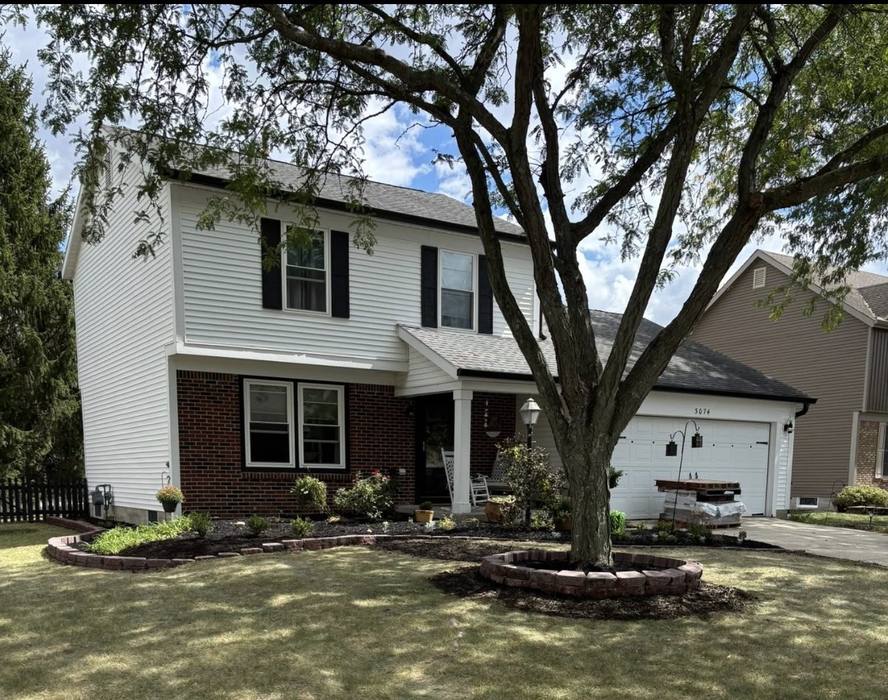 Front yard with fresh mulched beds and trimmed shrubs after a Jake's Landscaping refresh